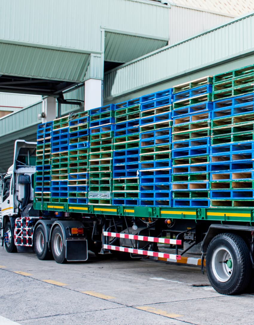 18-wheel truck and trailer hauling 48 x 40 wood pallets on trailer