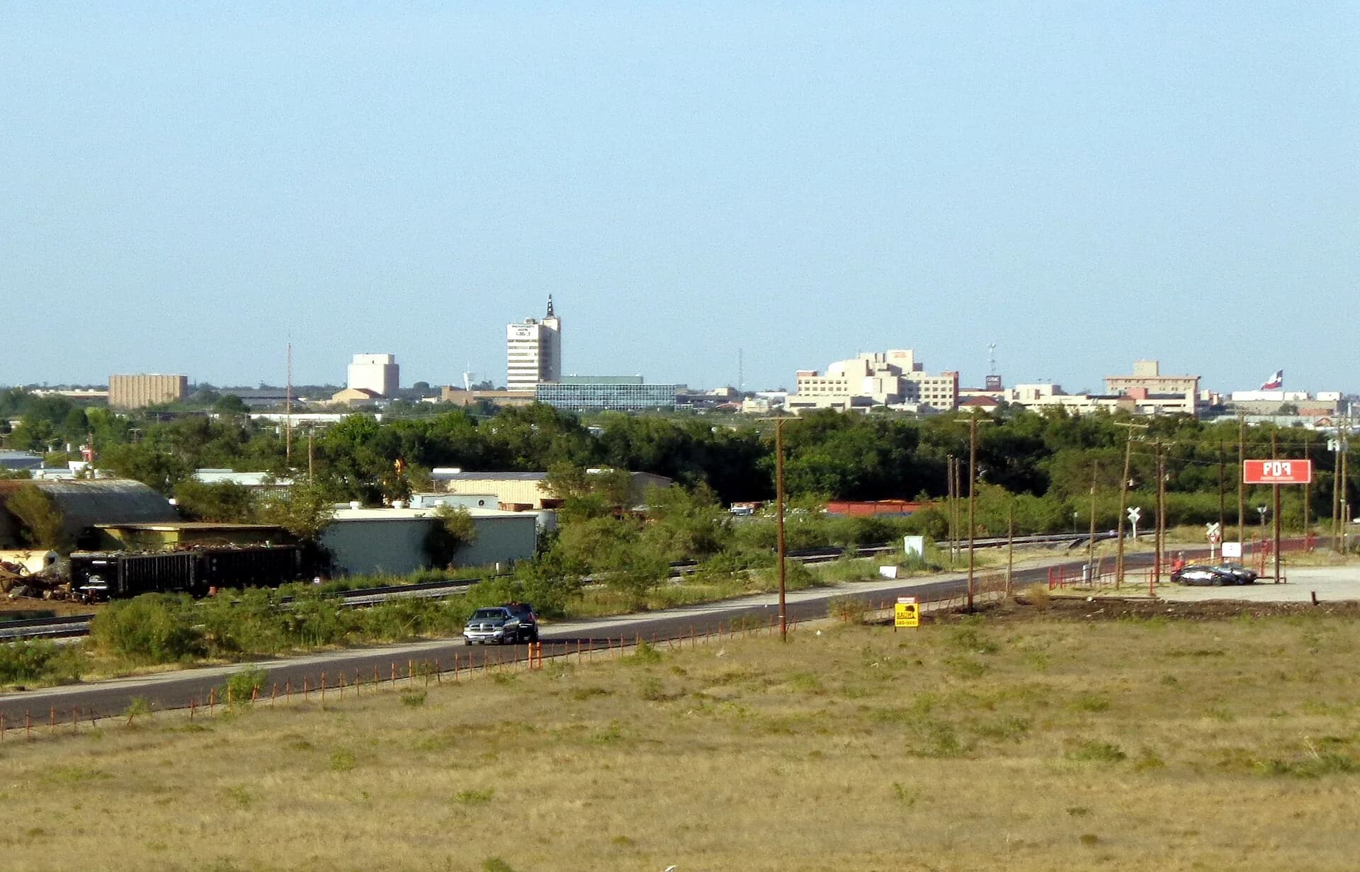 Distant downtown skyline across open land in Odessa, Texas