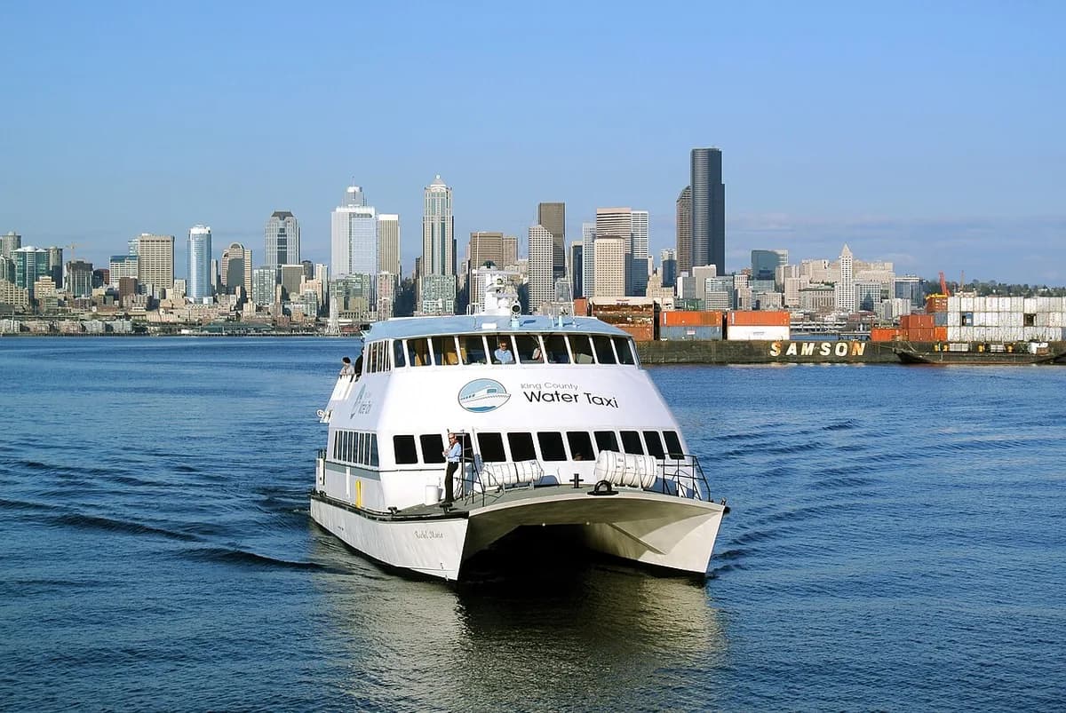 Water taxi on Elliott Bay with downtown skyline in Seattle, Washington