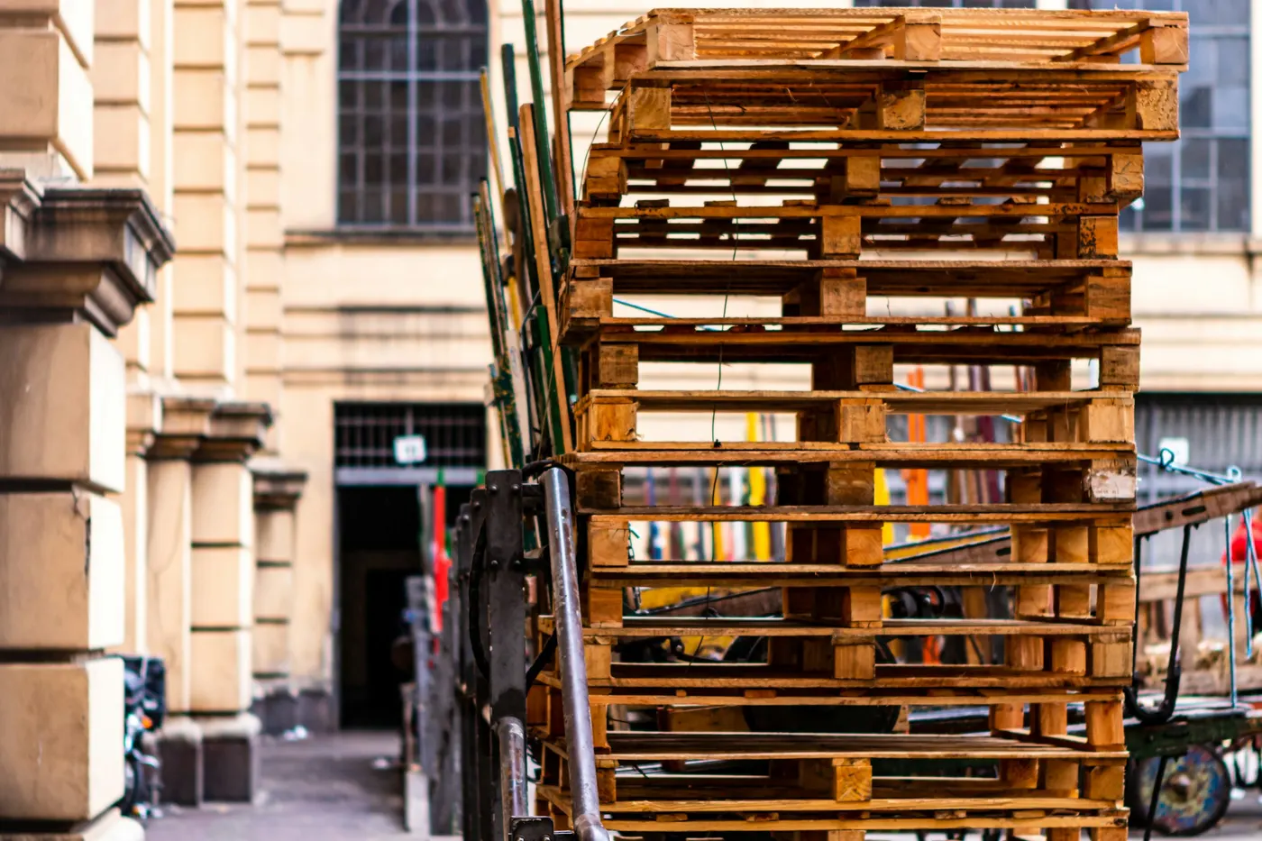 Stack of wood pallets in front of a building facade