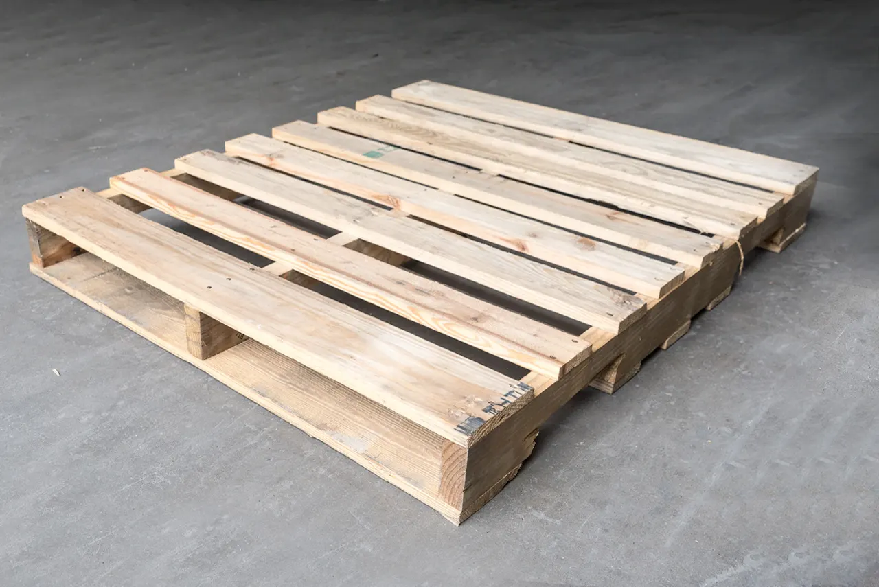 Clean light pine Grade A wood pallet on a grey concrete warehouse floor