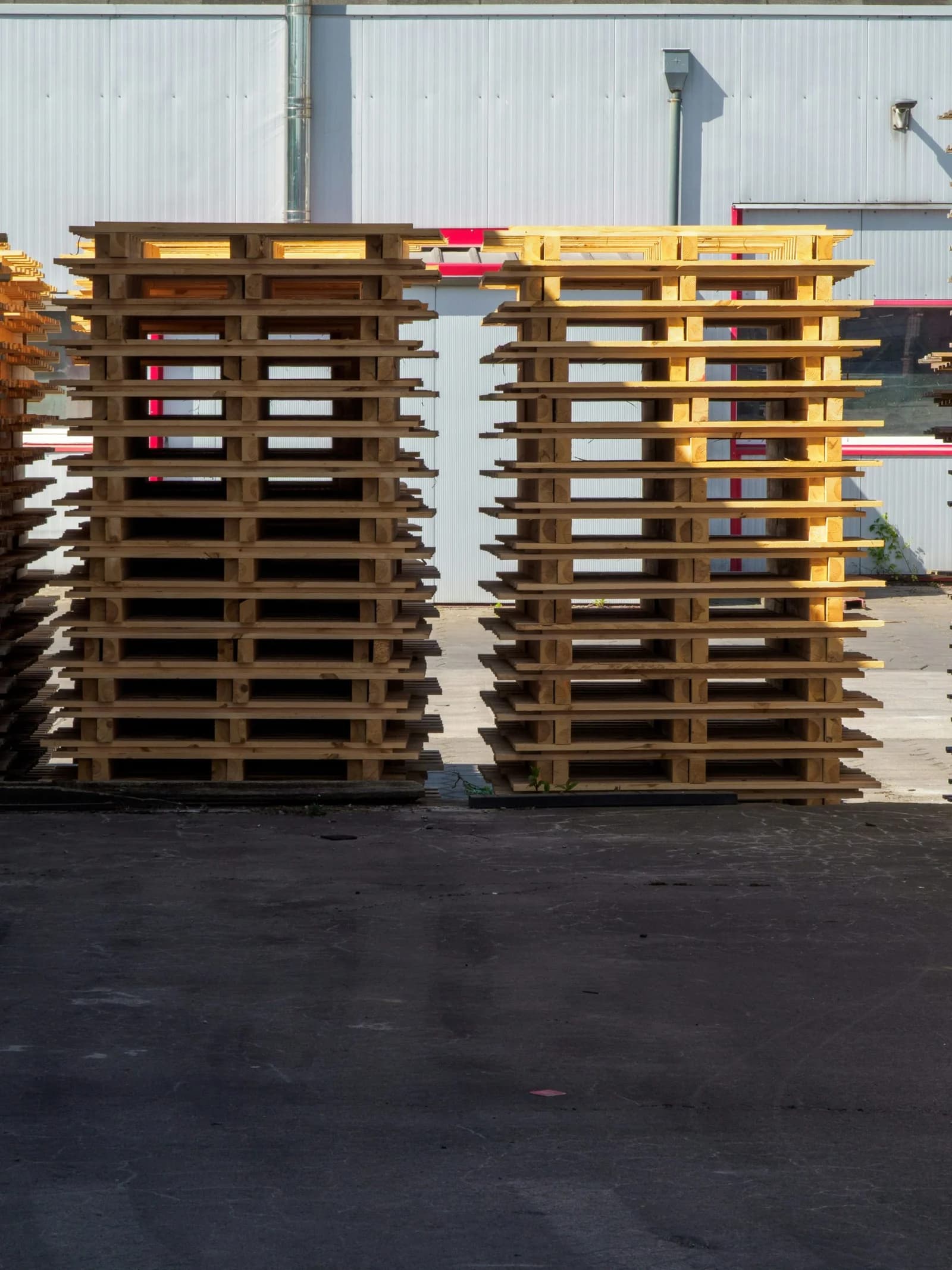 a stack of used pallets waiting to be hauled off in a work yard